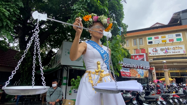 Cambodian activist dresses up as “Lady Justice” for trial