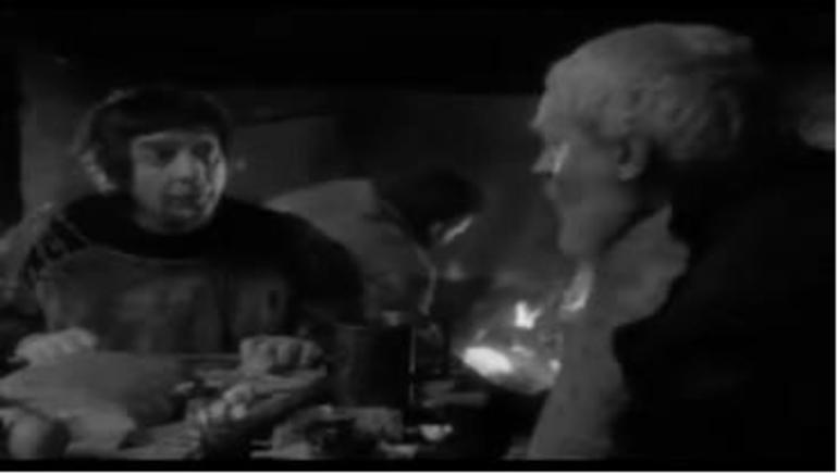 Figure 14: Lear and Fool at table, with hearth in the background