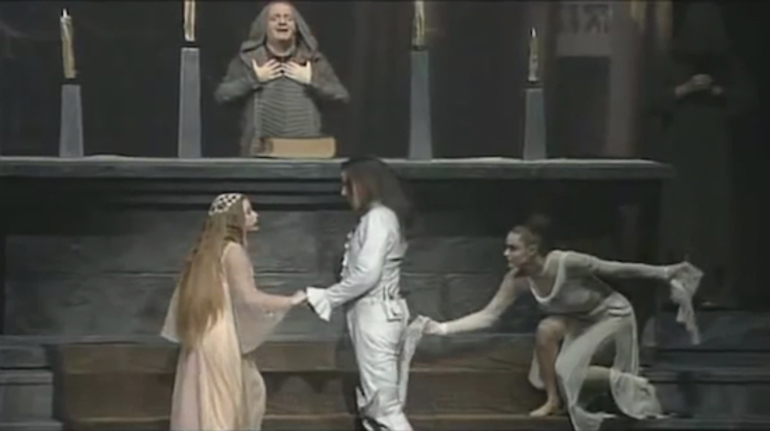 Screenshot from Roméo et Juliette, wedding scene, 2001.         Damien Sargue (Roméo), Cécilia Cara (Juliette), Jean Claude-Hadida (Friar Lawrence), Anne Mano (Death)