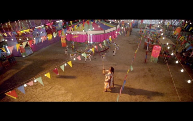 Fig. 1 Parvathy Baul performing Bari'r Kachhe Arshi Nagar in an empty fairground