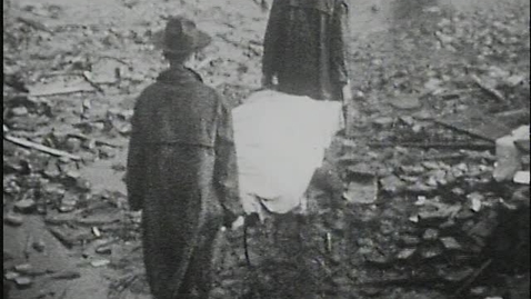 Thumbnail for entry Clip of National Guard personnel carrying bodies on stretchers from the Cooper Pants Company debris westward across the railroad tracks on Broad Street, Gainesville, Georgia, 1936 April 6