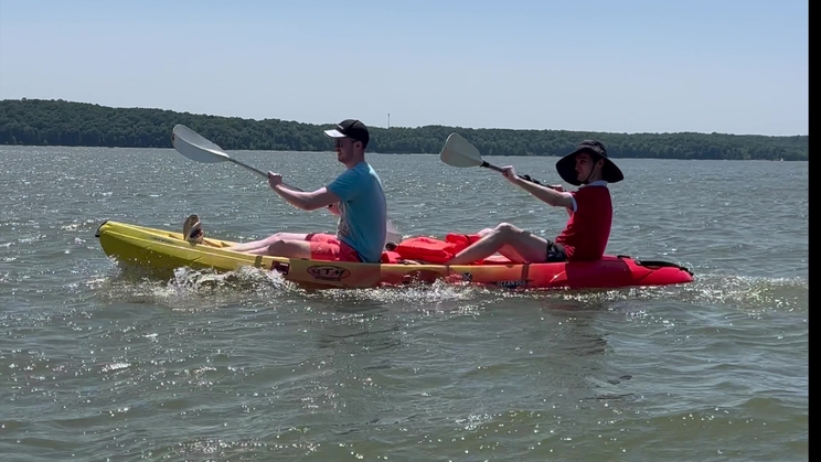 Two people in a kayak on lake Monroe. Links to global citizens scholarship video.