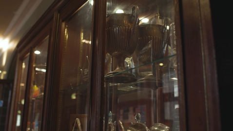 Thumbnail for trophies in wooden cabinet