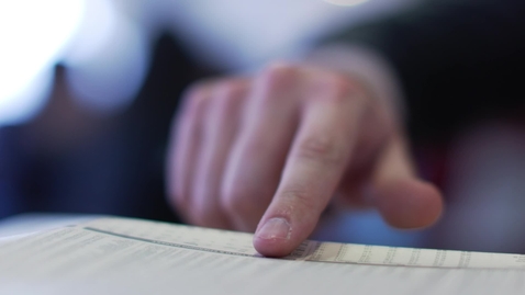 Thumbnail for Finger pointing at document text close-up