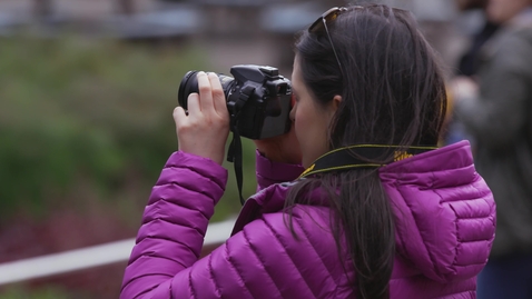 Thumbnail for Woman taking photos in city park